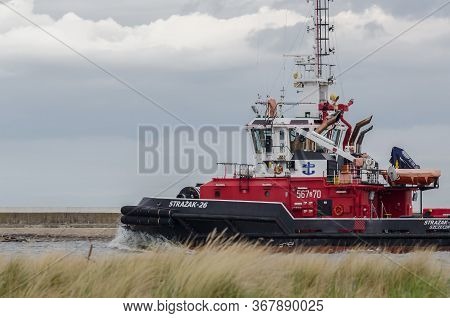 Swinoujscie, West Pomeranian / Poland - 2020: The Fireboat Floats In  Port Channel To Sea