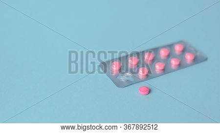 Pink Pills Pack In Blister Pack On A Blue Background