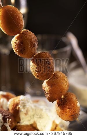 Round Fried Mozzarella Cheese Sticks Under Tzatziki Sauce From Yogurt With Cucumbers And Garlic On S