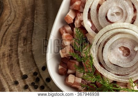 Italian Pancetta, Bacon Cubes, Diced Ham, Cutted Pork, Sliced Onion, Pepper In Square White Plate On