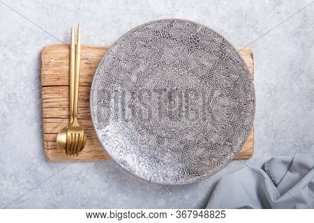 Empty Black Slate Plate On Grey Stone Table And Napkin. Food Background For Menu, Recipe. Table Sett