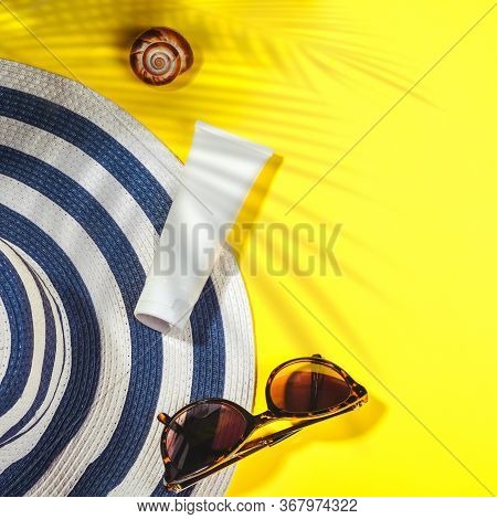 Sunprotection Objects. Hat With Sun Glasses And Protection Cream Spf Top On Bright Yellow Background