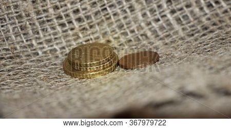 Some Euro Coins On Burlap Canvas Background. Little Money Concept. Powerty Concept