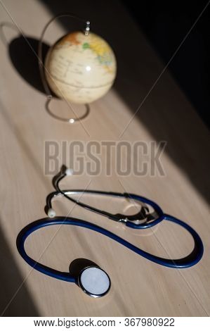 Globe And Stethoscope. The Concept Of Global Warming And Pollution. Phonendoscope And Earth Miniatur
