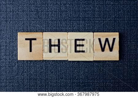 Word Thew From Gray Wooden Letters On A Black Table