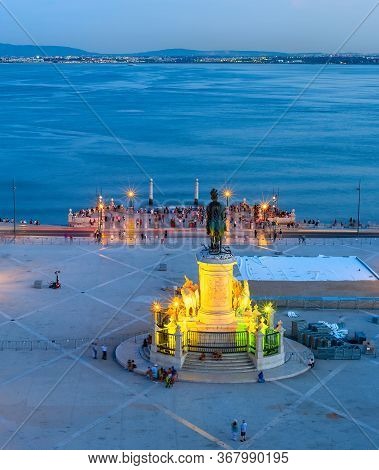 Aerial View To The Illuminated Commerce Square Of Lisbon With Statue Of King Jose I, Skyline With Bo