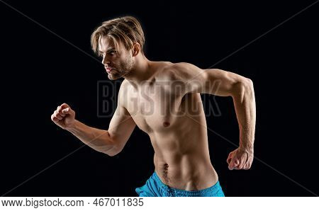 Muscular Man Running Forward. Photo Of Man With Muscular Sixpack In Running Pose.