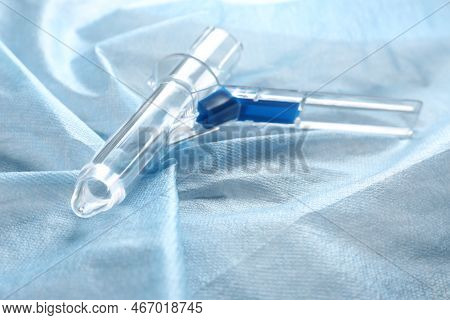 Anoscope On Light Blue Fabric. Hemorrhoid Treatment