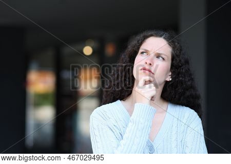 Serious Pensive Woman In The Street Looking Above