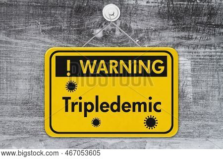 Tripledemic Message For Rsv, Covid-19 And Flu Yellow Warning Sign On Weathered Wood 3d Illustration