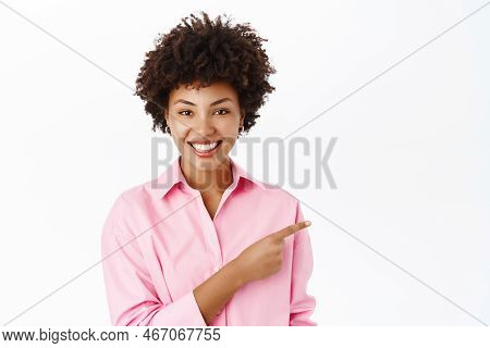 Portrait Of African American Office Woman, Saleswoman Pointing Finger Right, Smiling And Showing Adv