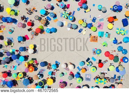 Aerial View Of Colorful Umbrellas On Sandy Beach And People