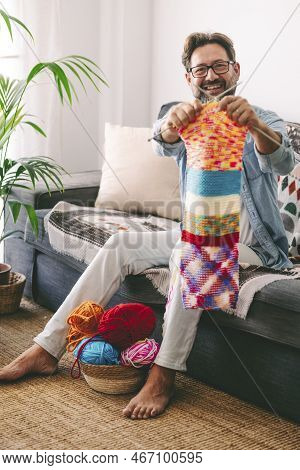 One Mature Man Alone At Home Spending Time In Knitting Work As Indoors Leisure Activity. Hobby For M