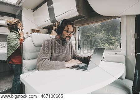 Camper Van Tourists Vacation Real Scene Lifestyle. Man And Woman Enjoying Motor Home Alternative Hou