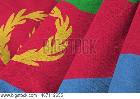 Eritrea Flag With Big Folds Waving Close Up Under The Studio Light Indoors. The Official Symbols And