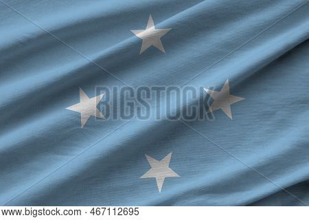 Micronesia Flag With Big Folds Waving Close Up Under The Studio Light Indoors. The Official Symbols 