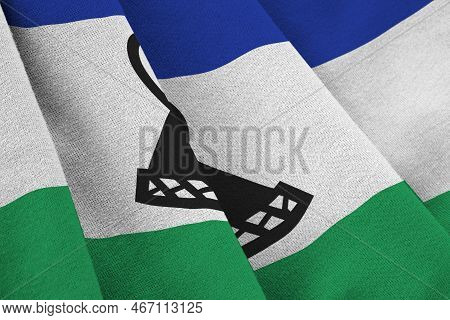 Lesotho Flag With Big Folds Waving Close Up Under The Studio Light Indoors. The Official Symbols And