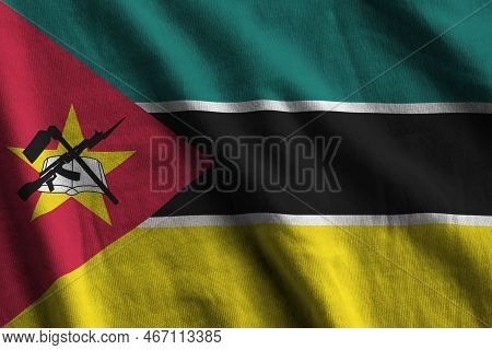 Mozambique Flag With Big Folds Waving Close Up Under The Studio Light Indoors. The Official Symbols 
