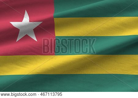 Togo Flag With Big Folds Waving Close Up Under The Studio Light Indoors. The Official Symbols And Co