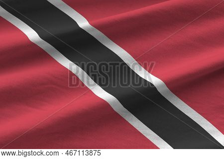 Trinidad And Tobago Flag With Big Folds Waving Close Up Under The Studio Light Indoors. The Official