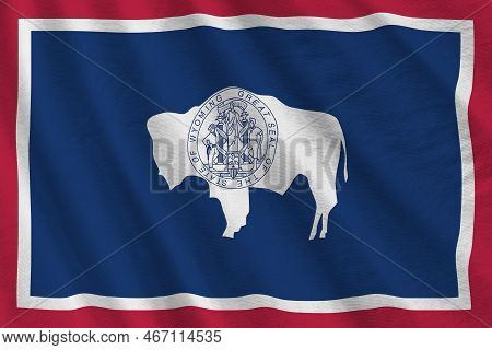 Wyoming Us State Flag With Big Folds Waving Close Up Under The Studio Light Indoors. The Official Sy