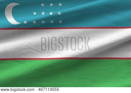 Uzbekistan Flag With Big Folds Waving Close Up Under The Studio Light Indoors. The Official Symbols 