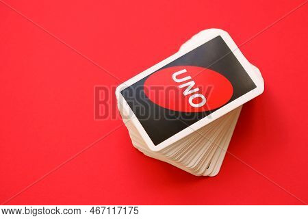 Ternopil, Ukraine - May 15, 2022: Many Colorful Uno Game Cards On Red Background Close Up. Uno Is An