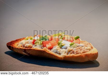 Mexican Molletes, Traditional Food With Bread, Beans, Cheese, Tomato And Chili