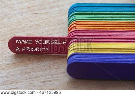 Make Yourself A Priority Text On Red Wooden Stick Sticking Out. Inspirational And Motivational Conce