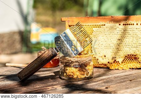 Beekeeper Collects The Honey. Beekeeping Tools Outside. Frame With Bees Wax Structure Full Of Fresh 