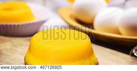 Quindim Or Brisa Do Lis, Tasty Dessert Made With Eggs In The Background