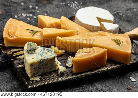 Parmesan. Different Types Of Cheese With Knife On A Dark Background. Cheeses Set Dor Blu Chedar Cama