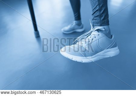 Legs Of Young Fit Woman Doing Exercise With Bodybar In Gym