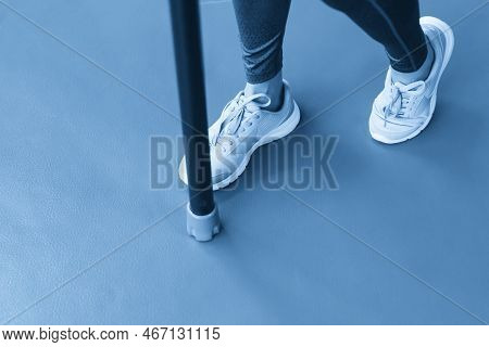 Legs Of Young Fit Woman Doing Exercise With Bodybar In Gym