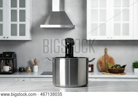 Pot With Sous Vide Cooker On Table In Kitchen. Thermal Immersion Circulator