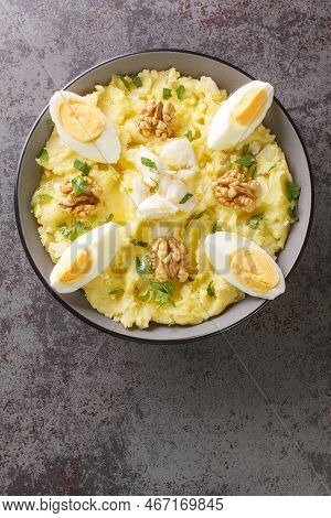 Spanish Cuisine Mashed Potatoes With Cod And Garlic Served With Walnuts And Boiled Eggs Close-up In 