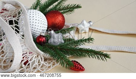 String Bag With Christmas Toys On The Beage Flat Lay Background With Copy Space.