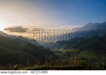 Dramatic Sunset Over Mountain Landscape. Beautiful Landscape Foggy Hills Twilight Time. Blue Golden