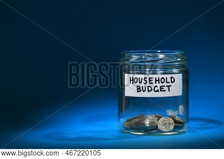 A Household Budget Sign On A Glass Jar With Just A Handful Of Coins Inside Illustrating The Lack Of 
