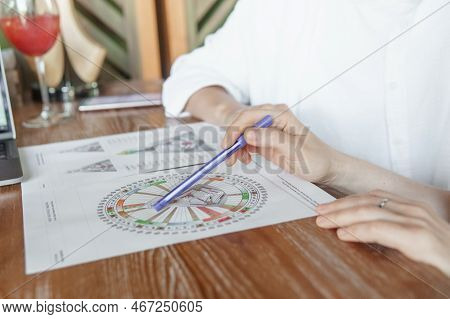 Tver, Russia - August 2, 2021. A Woman In A Cafe At A Table Is Studying The Design Of A Person. The 