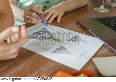 Tver, Russia - August 2, 2021. A Woman In A Cafe At A Table Is Studying The Design Of A Person. The 