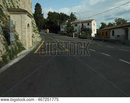 City Street With Bus Stop Pad On Asphalt Road On Sunny Day
