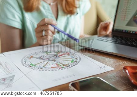 Tver, Russia - August 2, 2021. A Woman In A Cafe At A Table Is Studying The Design Of A Person. The 