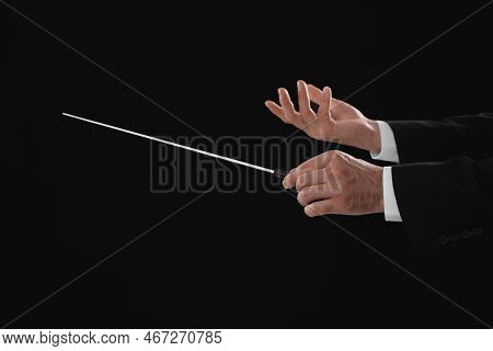 Professional Conductor With Baton On Black Background, Closeup