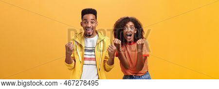 Two Friends Cheering And Supporting Mate On Competition Yelling Joyfully Clenching Fists In Supporti