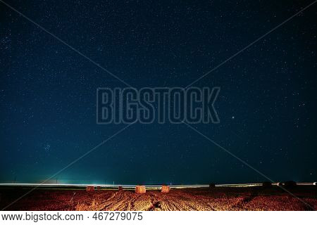 Agricultural Colorful Background Copy Space. Night Starry Sky Above Rural Landscape Field Meadow Wit