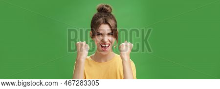 Woman With Spirit Of Winner Raising Clenched Fists Smiling Excited And Supportive Cheering Being Rea
