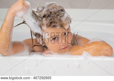 Kids Bathing. Child In The Bath With Bubbles. Happy Child Enjoying Bath Time. Little Boy Smiling In 
