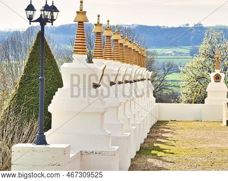 La Boulaye, France - April Circa, 2018. Several Small White Stupas With Traditional Eyes Of Buddha P