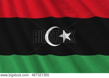 Libya Flag With Big Folds Waving Close Up Under The Studio Light Indoors. The Official Symbols And C